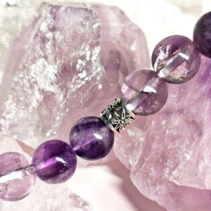 Close-up detail of polished amethyst beads showing texture