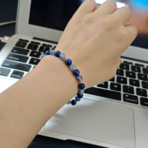Woman wearing handmade blue kyanite bracelet for calm focus and emotional balance
