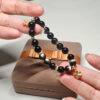 Main image of silver obsidian bracelet with four-leaf clover charm