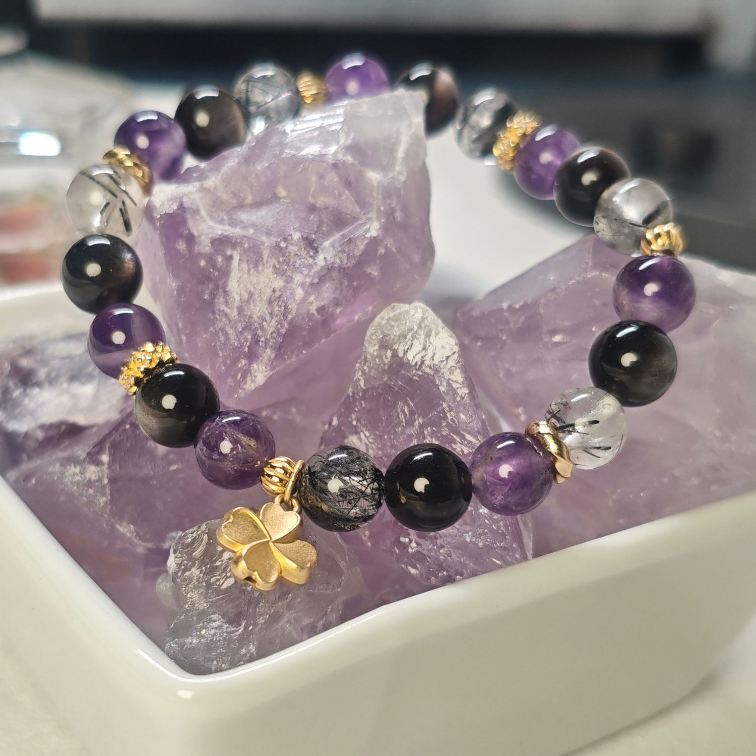 Main image of the Four-Leaf Clover Protection Bracelet featuring amethyst, silver obsidian, black rutilated quartz, and a four-leaf clover charm