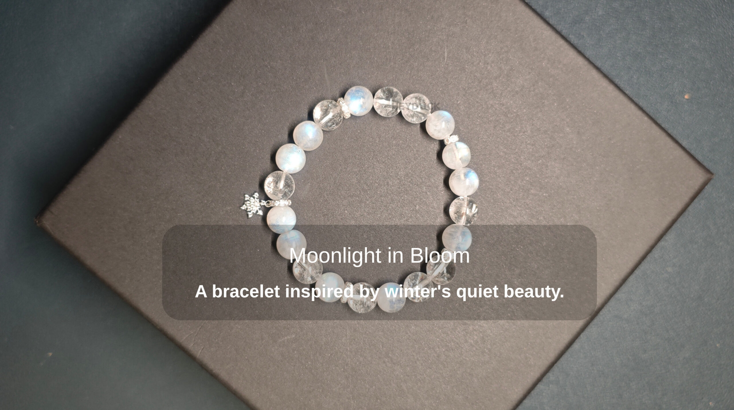 Blue Moonstone and Clear Quartz Snowflake charm bracelet inspired by winter’s quiet beauty and emotional harmony.