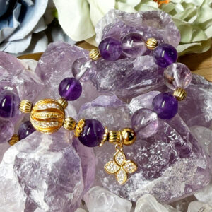Natural amethyst and azeztulite crystal bracelet with gold-plated accents and handcrafted details.