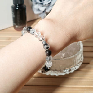 Woman wearing a Silver Obsidian Wealth Shield Bracelet for energy protection, confidence, and steady prosperity