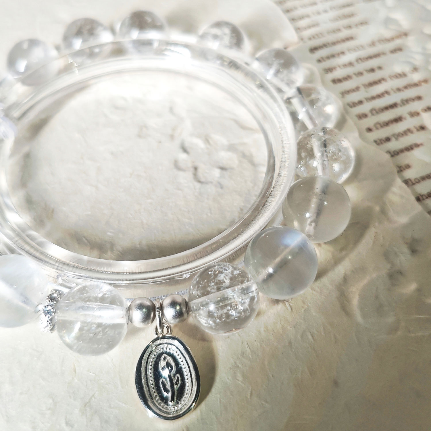 Detailed view of the 925 sterling silver tulip charm and spacer beads on the Moonstone Tulip Promise Bracelet