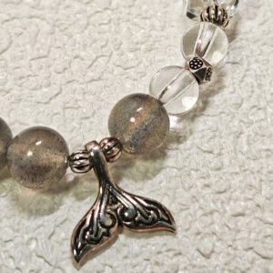 Close-up detail of the 925 sterling silver mermaid tail charm and spacer beads on the Gray Moonstone Tide Bracelet