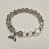 Gray Moonstone Tide Bracelet with clear quartz and sterling silver mermaid tail charm, inspired by moonlight, calm protection, and gentle transformation