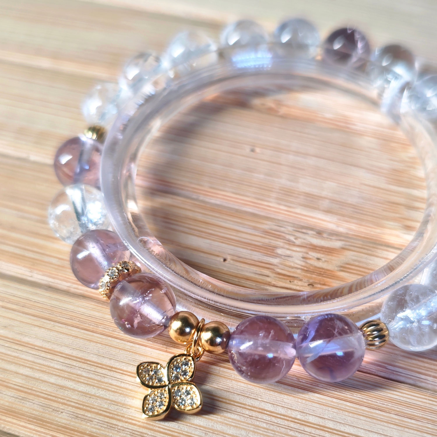 Close-up of Ice Lavender Quartz, Ice Clear Quartz beads and gold-plated four-leaf clover charm details