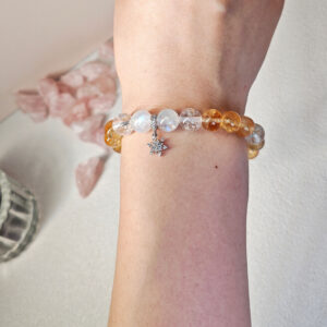 Woman wearing Moonstone and Golden Ice Quartz Prosperity Bracelet as meaningful crystal jewelry for daily style and mindful living
