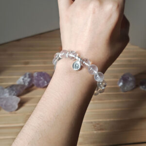 Woman wearing Moonstone Tulip Promise Bracelet with a delicate silver tulip charm for an elegant everyday look
