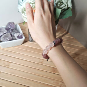 Woman wearing the Rose Quartz True Love Bracelet with natural pink crystals and 925 sterling silver sakura accents for an elegant everyday look.