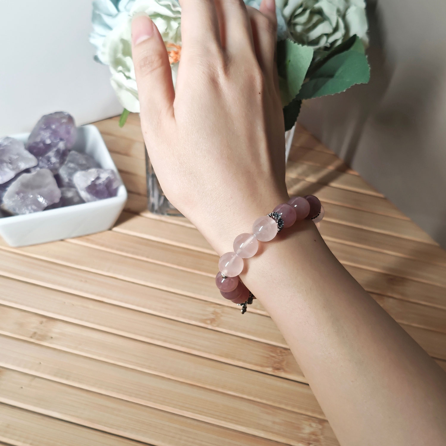 Woman wearing the Rose Quartz True Love Bracelet with natural pink crystals and 925 sterling silver sakura accents for an elegant everyday look.