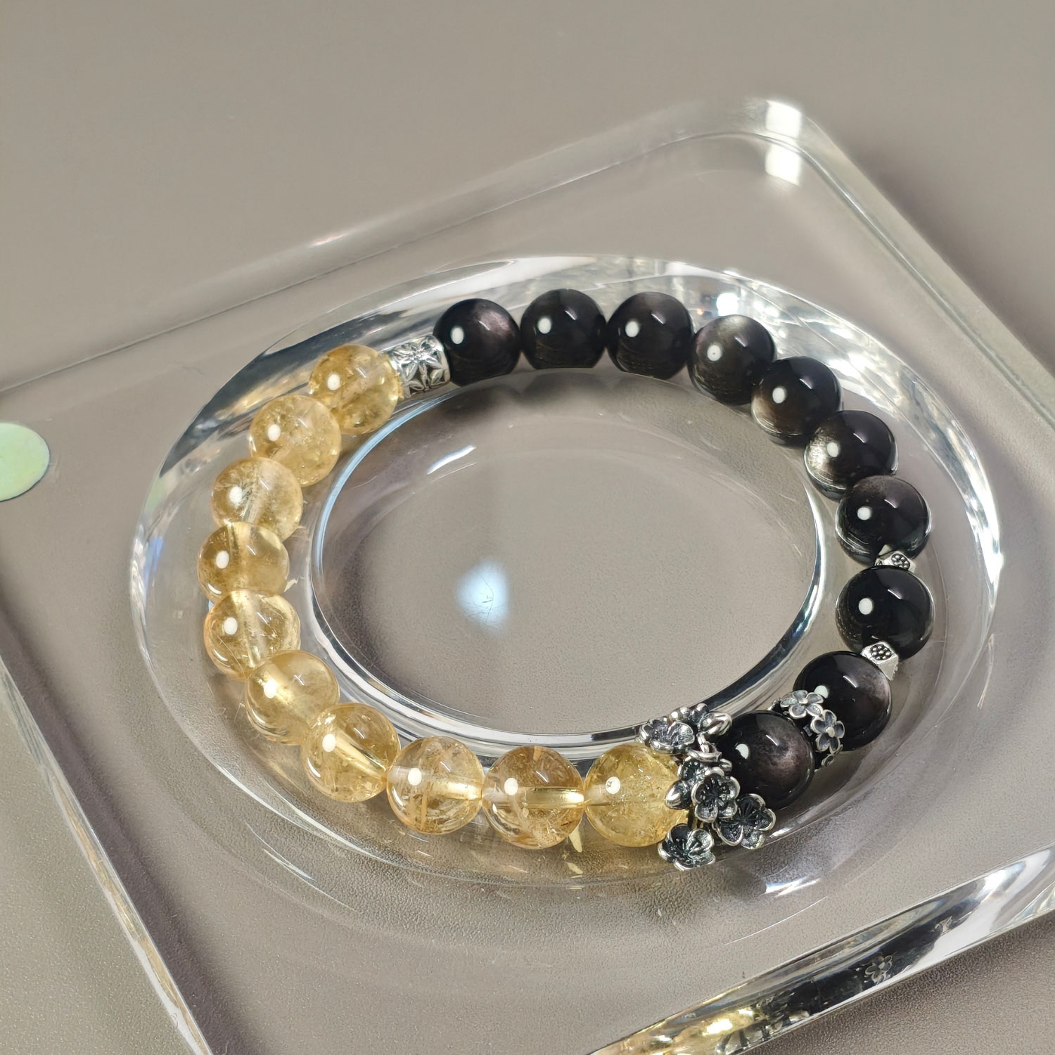 Natural Silver Obsidian and Golden Ice Quartz bracelet handcrafted to inspire confidence, positive momentum, and success
