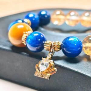 Detailed view of the gold-plated crown charm and 925 sterling silver spacers on CrownReign CL