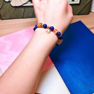CrownReign CL wealth and leadership crystal bracelet worn on a woman's wrist