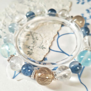 Luminous Veil Crystal Bracelet AuroraGain CL showcasing the elegant contrast of golden, deep blue, aqua, and ice-clear natural crystals