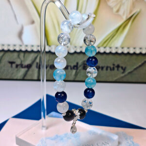 Crystal bracelet for protection and clarity featuring aquamarine, kyanite, moonstone, silver obsidian, and ice clear quartz