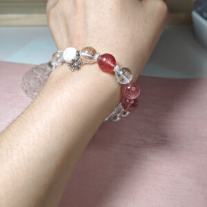 Snow Whisper Clear Heart Crystal Bracelet worn on a woman's wrist, showcasing the natural crystal beads and snowflake charm