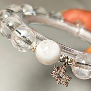 Close-up of White Phantom, Strawberry Quartz, Ice Clear Quartz beads and 925 sterling silver platinum-plated snowflake charm