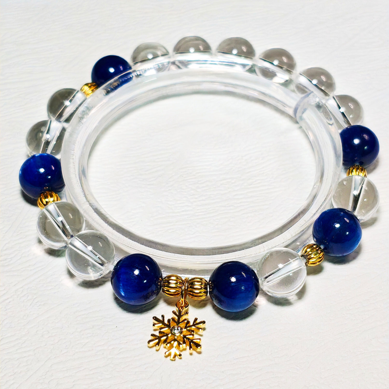 Crystal bracelet for clear communication featuring deep blue Kyanite, Clear Quartz, and a meaningful snowflake design