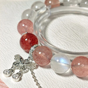 Close-up detail of natural Strawberry Quartz, Blue Moonstone, 925 sterling silver spacers, and butterfly charm