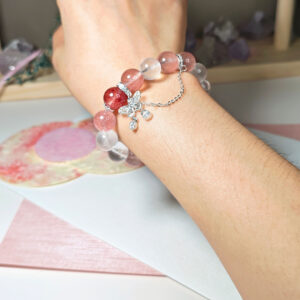 Strawberry Quartz and Blue Moonstone crystal bracelet worn on a woman's wrist for an elegant everyday look