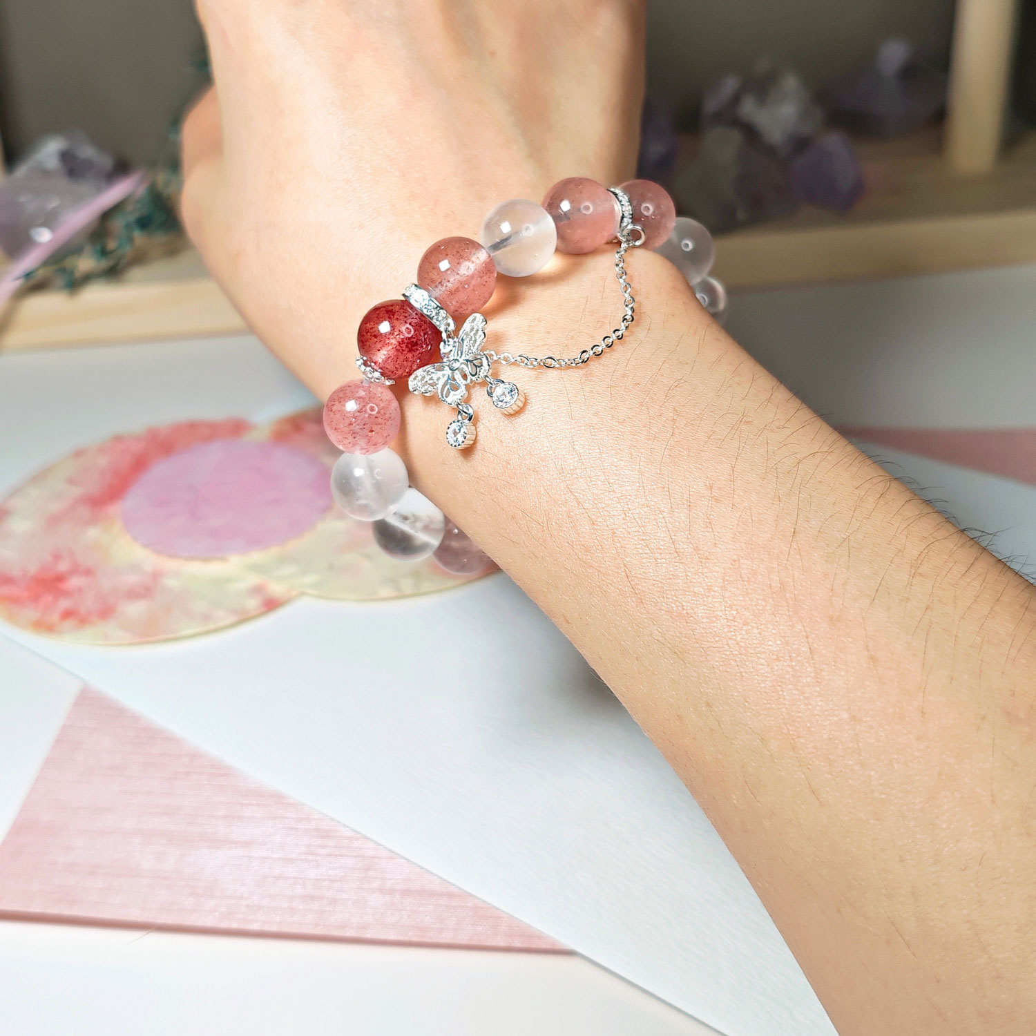 Strawberry Quartz and Blue Moonstone crystal bracelet worn on a woman's wrist for an elegant everyday look