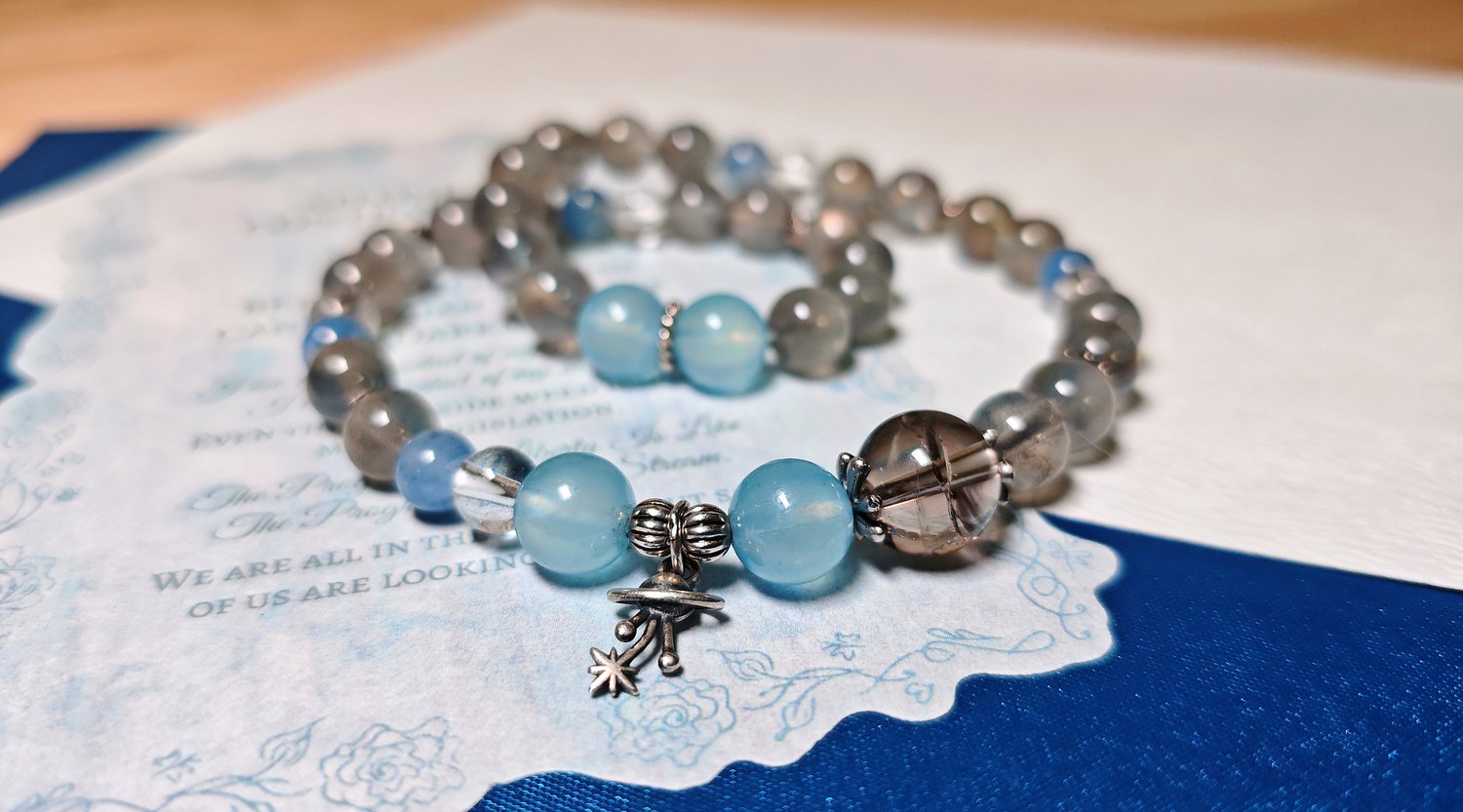 Double-wrap crystal bracelet for women in pale aquamarine and grey moonstone with a sterling silver planet charm