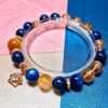 Golden Tiger's Eye Citrine Bracelet with blue kyanite, front view on a pale background