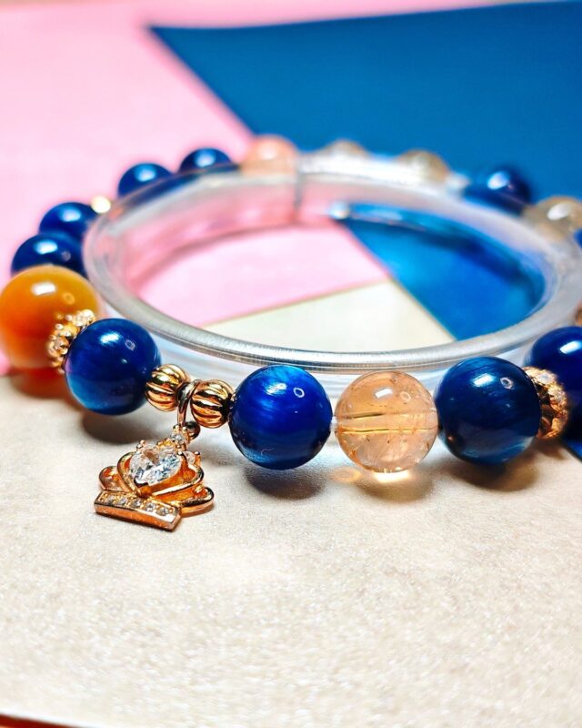 Bracelet standing on a display ring in daylight, kyanite and citrine catching the light
