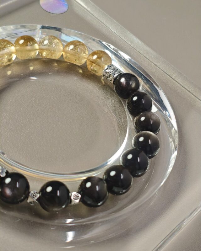 Detail of silver obsidian beads with engraved sterling silver spacer beads on the equinox crystal bracelet