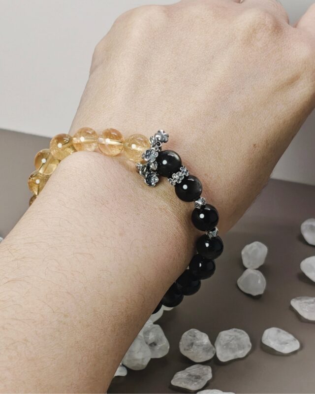 Two-tone silver obsidian citrine bracelet worn on the wrist, showing the stretch fit