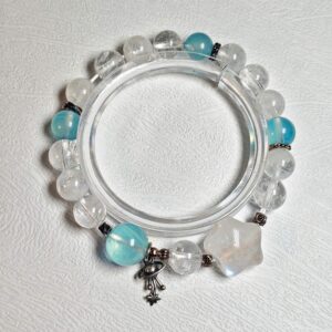 Blue moonstone aquamarine clear quartz bracelet in a full circle seen from above, planet charm at the bottom and one star-shaped moonstone at the lower right