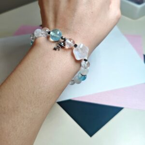 Blue moonstone aquamarine clear quartz bracelet worn on the wrist in daylight