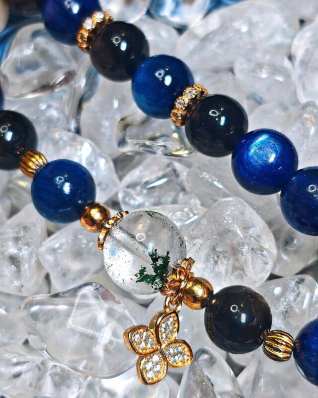 Close view of the Steady Presence crystal bracelet resting on a raw quartz cluster.