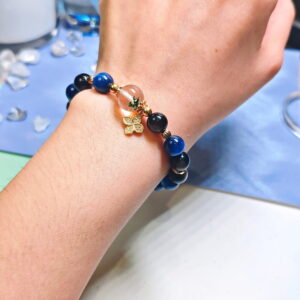 Green phantom quartz bracelet worn on the wrist, with the kyanite, green phantom quartz and silver obsidian beads in view.
