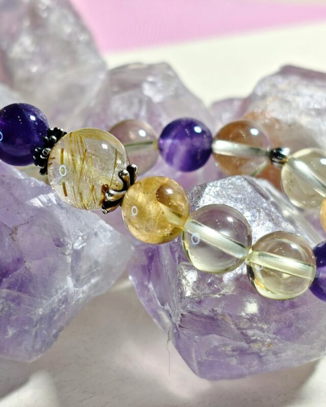 Close view of golden rutilated quartz, ice lemon quartz and amethyst beads with oxidized s925 sterling silver spacers
