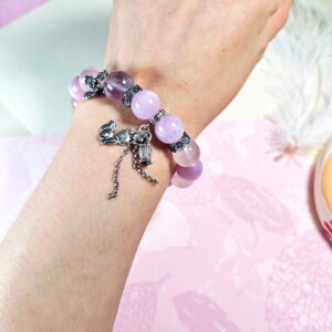 Purple rutilated quartz bracelet worn on the wrist, with the star rose quartz and cat's eye kunzite beads in view.